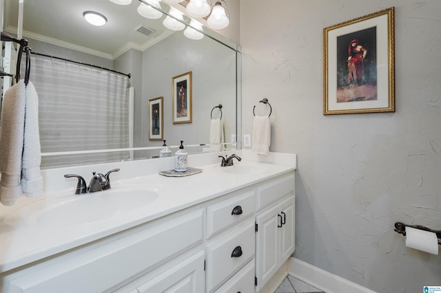 bathroom with tile patterned flooring, vanity, and crown molding