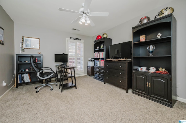 carpeted office space with ceiling fan