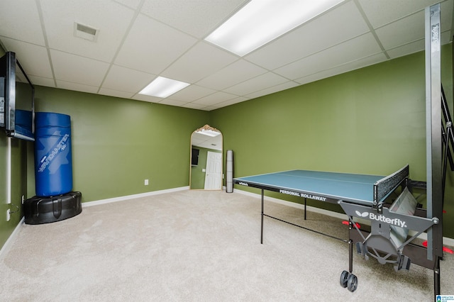 recreation room with a drop ceiling and carpet