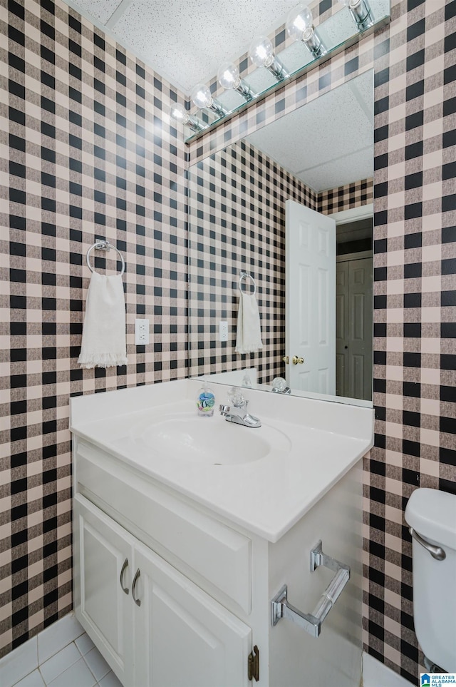 bathroom featuring tile patterned floors, vanity, and toilet