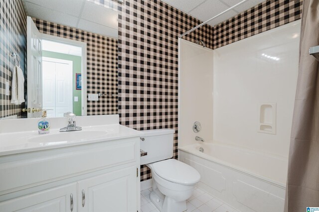 full bathroom featuring vanity, tile patterned floors, a paneled ceiling, and shower / tub combo with curtain