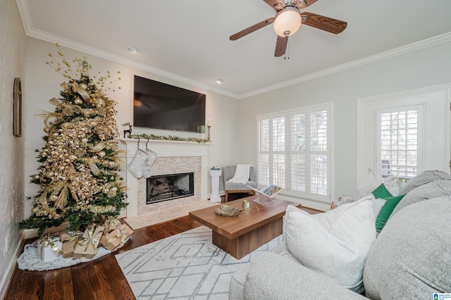 living room with hardwood / wood-style flooring, ceiling fan, and ornamental molding