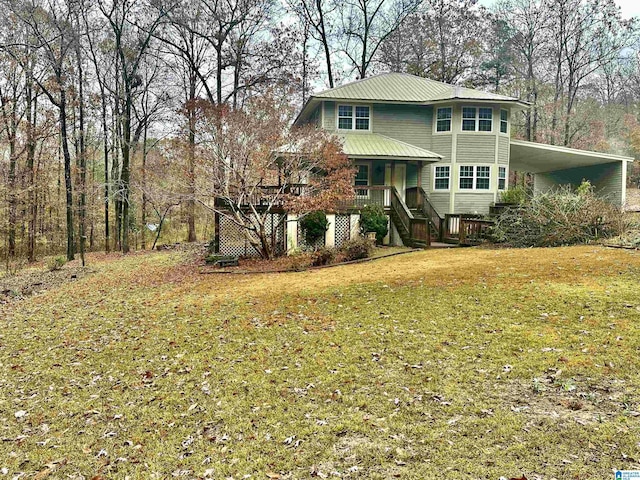 front facade with a front yard, a porch, and a carport