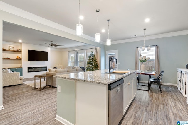 kitchen with white cabinets, pendant lighting, dishwasher, plenty of natural light, and an island with sink