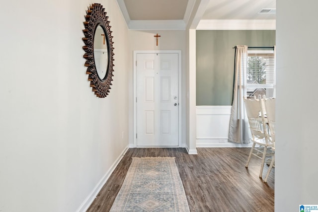 entrance foyer with crown molding and dark hardwood / wood-style flooring