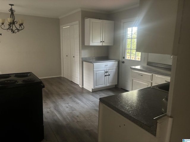 kitchen with dark wood-type flooring, decorative light fixtures, a notable chandelier, black electric range, and white cabinetry