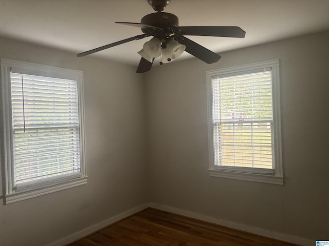 unfurnished room featuring dark hardwood / wood-style flooring and ceiling fan