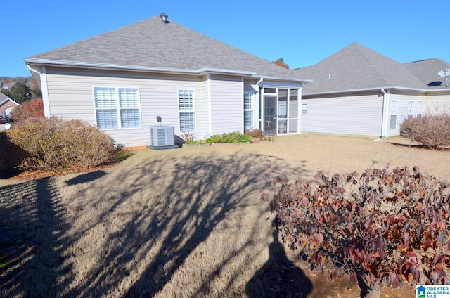 back of property with a sunroom and central AC unit