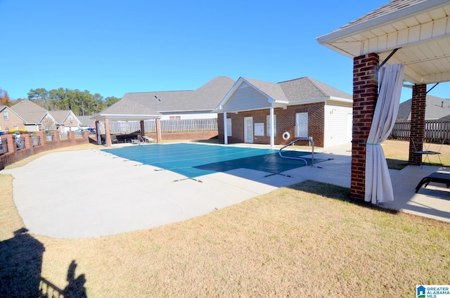 view of pool featuring a yard and a patio area