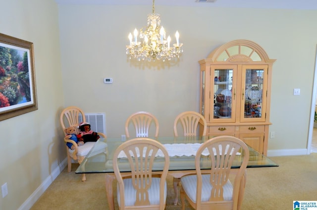 dining area with light carpet and a chandelier