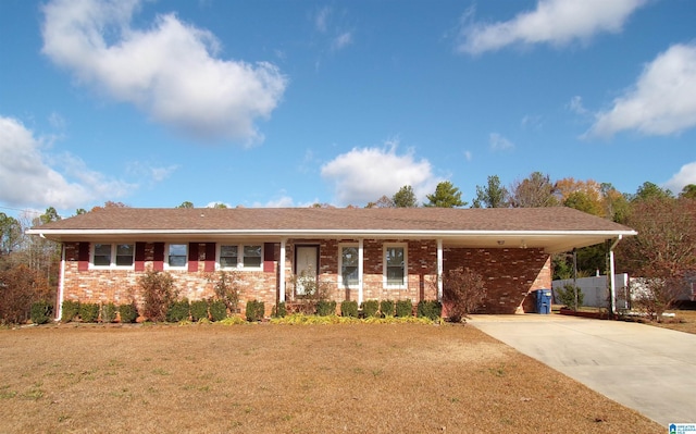 ranch-style home with a carport and a front lawn