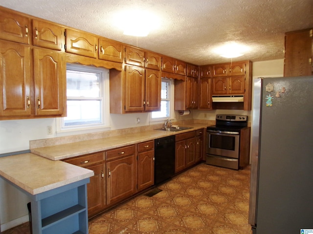 kitchen featuring a textured ceiling, sink, and appliances with stainless steel finishes