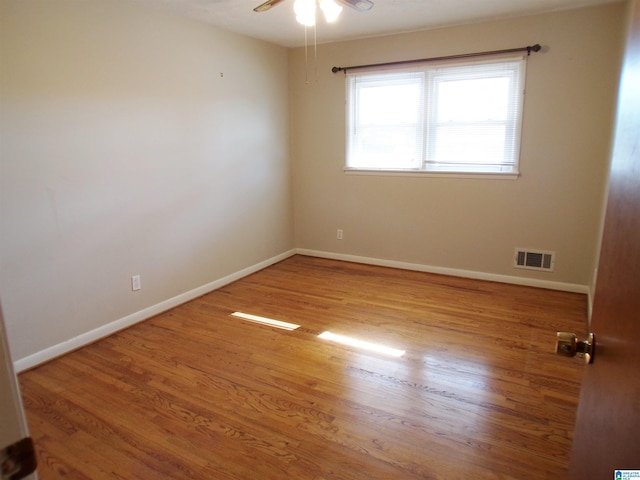 spare room featuring light wood-type flooring and ceiling fan