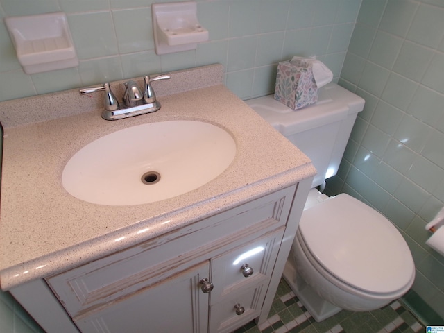 bathroom with decorative backsplash, vanity, tile walls, and toilet