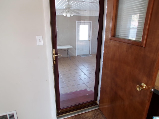 doorway to outside featuring tile patterned flooring and ceiling fan