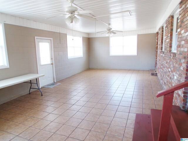 empty room featuring ceiling fan and light tile patterned floors