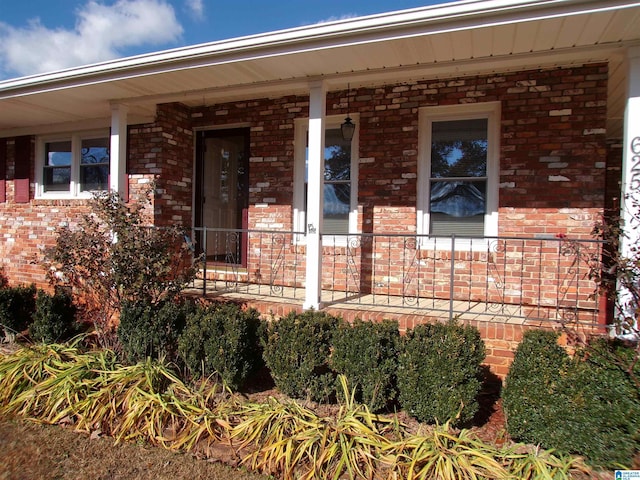 view of exterior entry featuring a porch