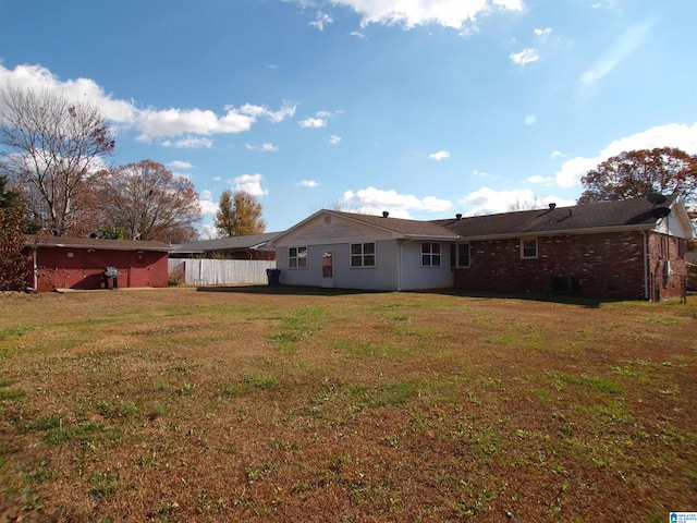 rear view of house with a yard