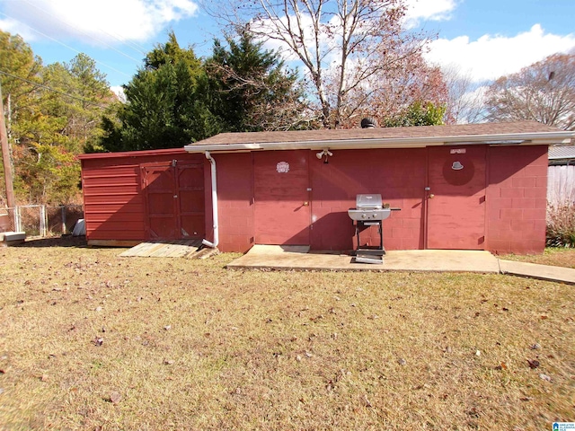 view of outbuilding featuring a lawn