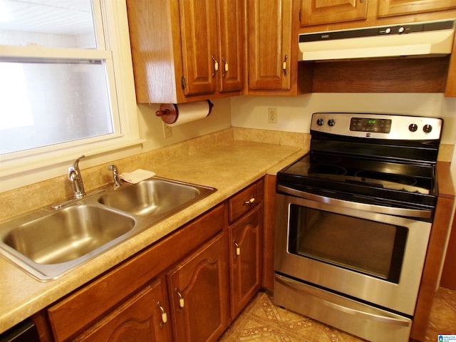 kitchen with stainless steel electric stove and sink