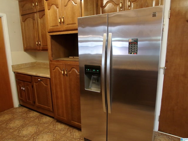 kitchen featuring stainless steel fridge with ice dispenser