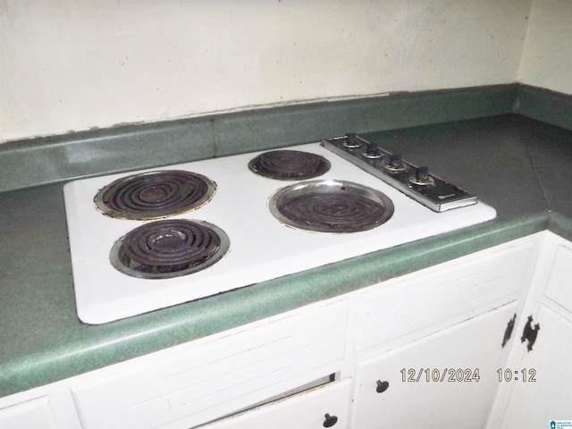 interior details with white cabinets and white stovetop