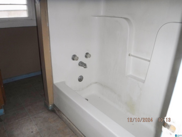 bathroom featuring shower / tub combination and tile patterned flooring