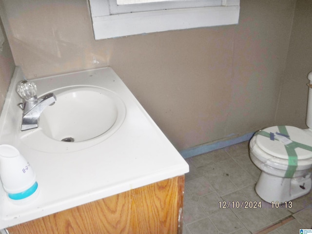 bathroom featuring tile patterned flooring, vanity, and toilet