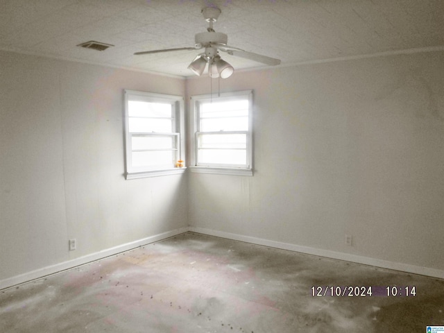 spare room with ceiling fan and concrete floors