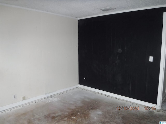 spare room with a textured ceiling