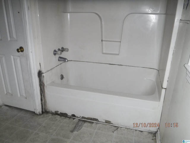 bathroom featuring tile patterned floors and  shower combination