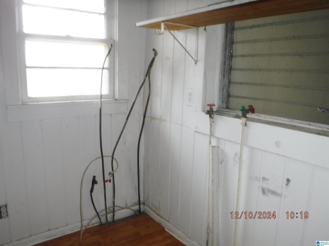 room details featuring wood walls and wood-type flooring