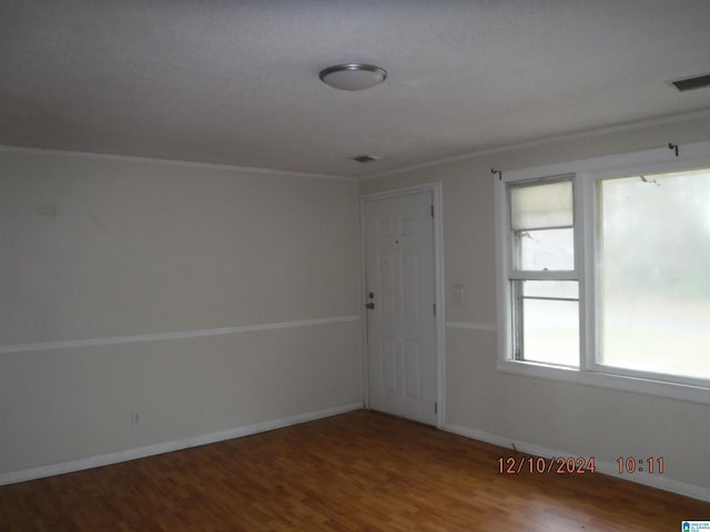 unfurnished room with hardwood / wood-style flooring