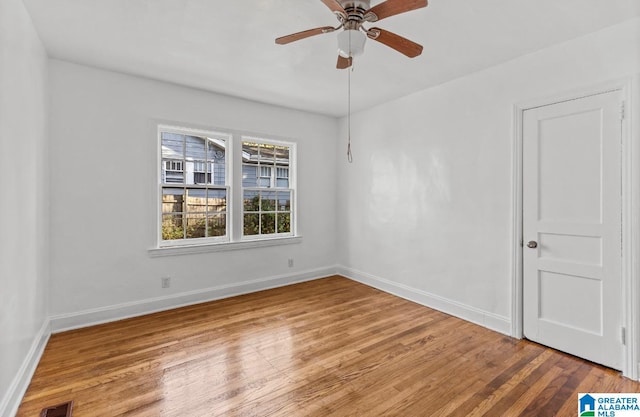 unfurnished room with ceiling fan and hardwood / wood-style floors