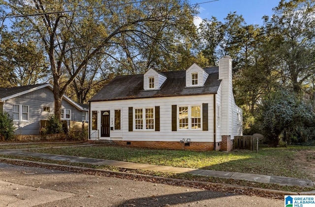 new england style home with a front lawn