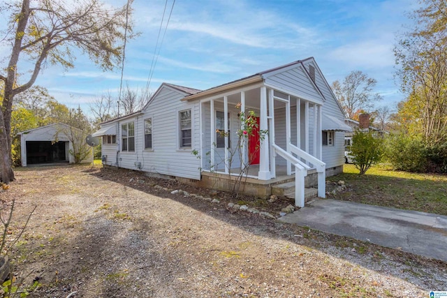 manufactured / mobile home with a garage and an outbuilding