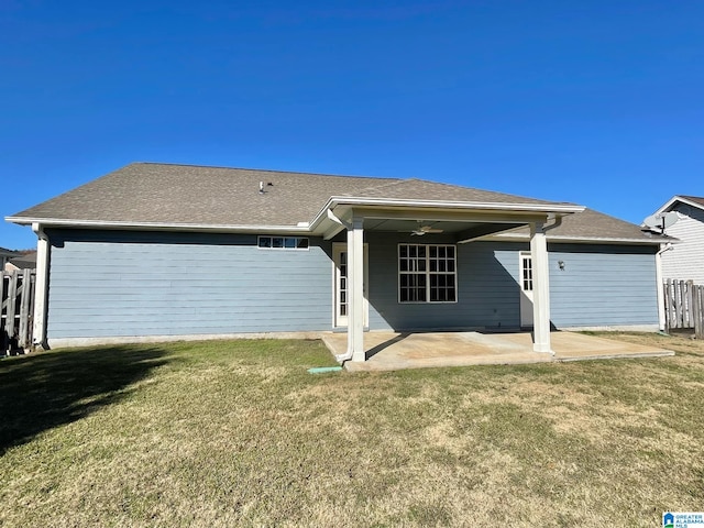 back of property featuring ceiling fan, a yard, and a patio