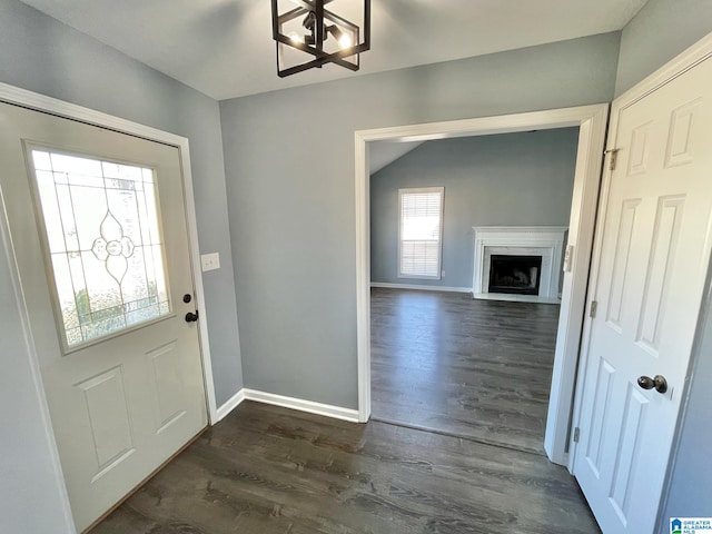 foyer with vaulted ceiling, a chandelier, and dark hardwood / wood-style floors