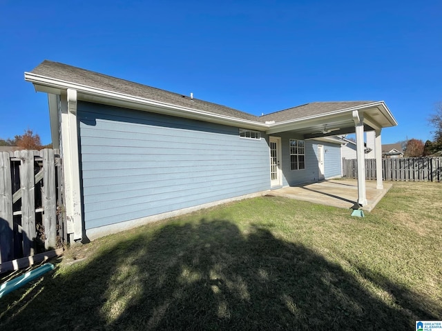 back of property featuring a lawn and a patio area