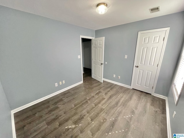 unfurnished bedroom with hardwood / wood-style flooring