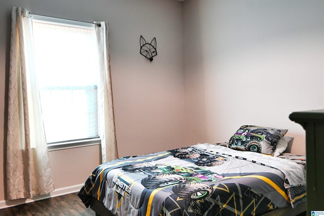 bedroom with dark hardwood / wood-style floors