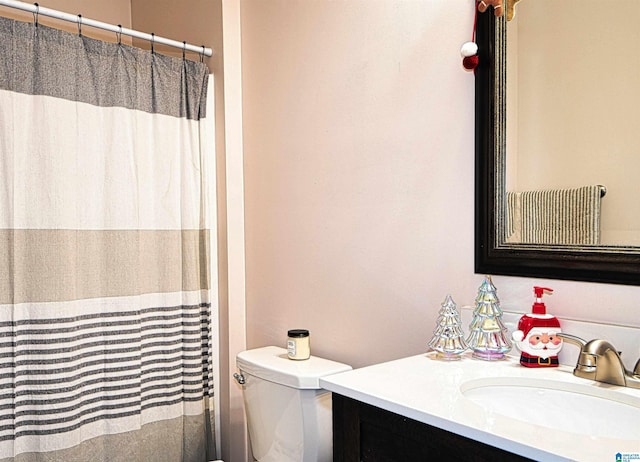 bathroom featuring toilet and vanity