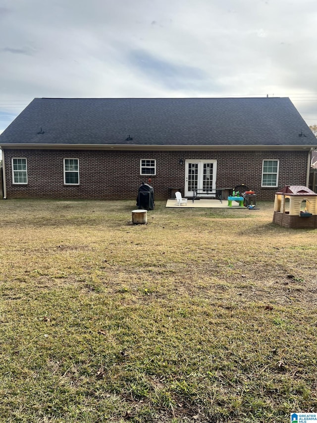 back of property featuring a patio area, french doors, and a yard