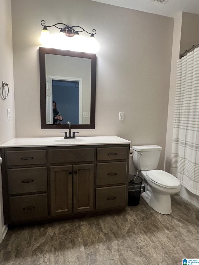 bathroom with toilet and vanity