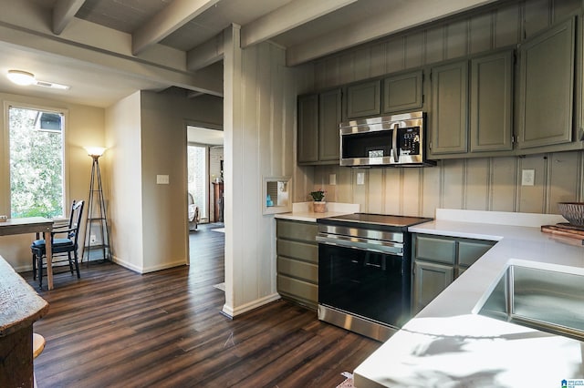 kitchen featuring beamed ceiling, dark hardwood / wood-style floors, and appliances with stainless steel finishes