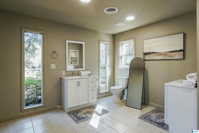 bathroom featuring tile patterned floors, a wealth of natural light, and toilet