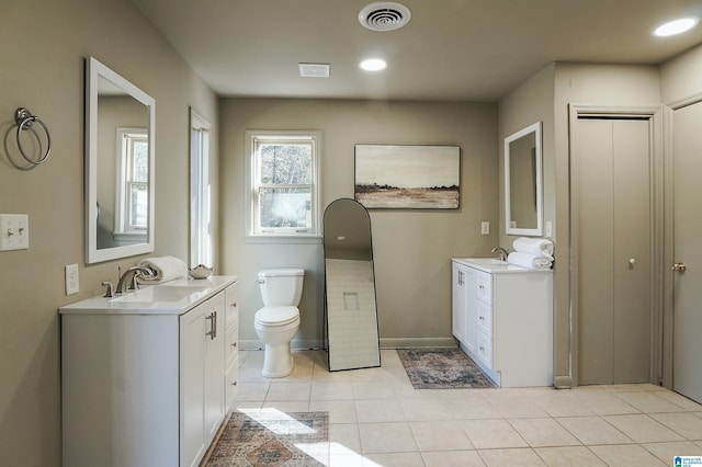 bathroom featuring tile patterned flooring, vanity, and toilet