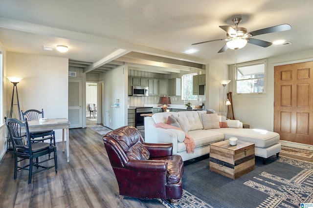 living room featuring beamed ceiling, dark hardwood / wood-style floors, and ceiling fan