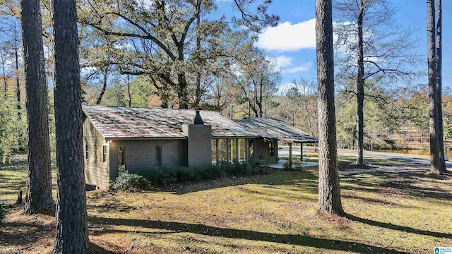 view of side of property with a lawn