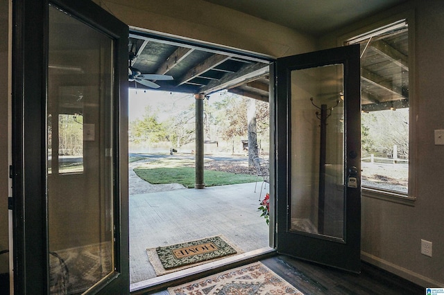 foyer with dark hardwood / wood-style floors and ceiling fan